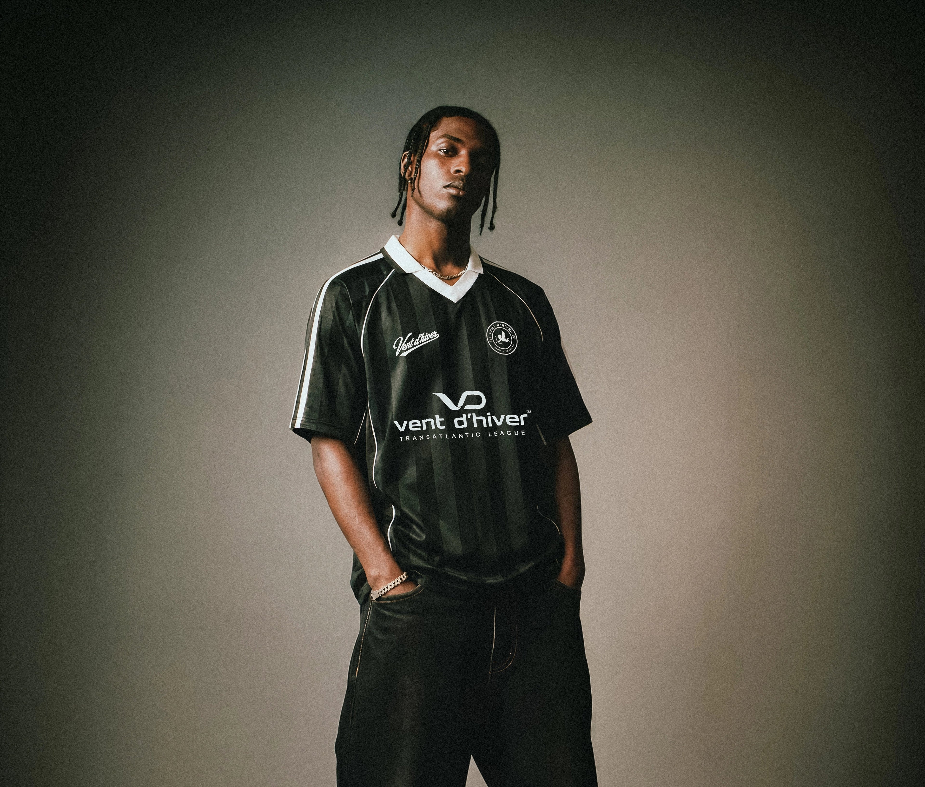 Person wearing a black sports jersey with visible branding against a plain background