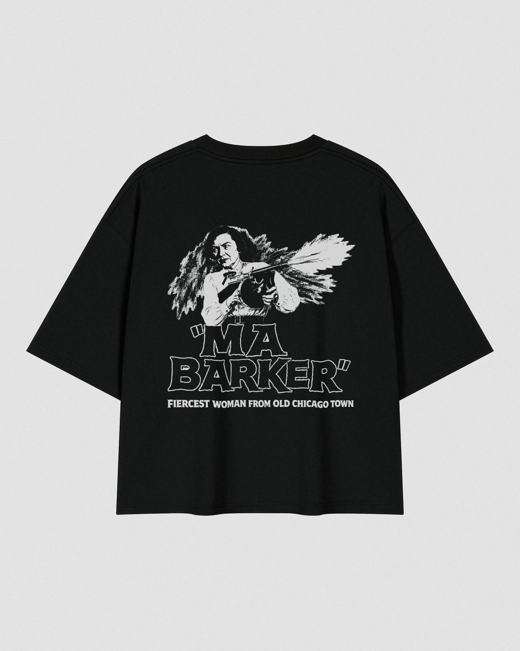 Black oversized heavyweight cotton T-shirt featuring a small white VENT D'HIVER® logo on the front chest. The back showcases a vintage monochrome illustration of Ma Barker holding a Thompson submachine gun, with large distressed "MA BARKER" typography and the phrase "FIERCEST WOMAN FROM OLD CHICAGO TOWN" beneath.