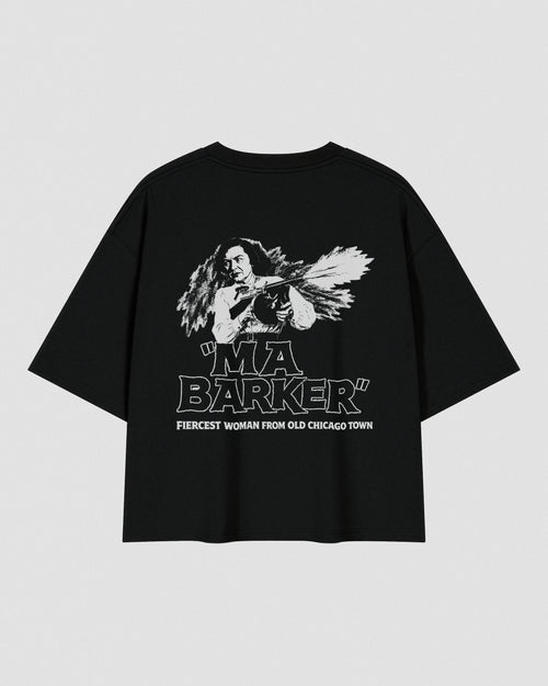 Black oversized heavyweight cotton T-shirt featuring a small white VENT D'HIVER® logo on the front chest. The back showcases a vintage monochrome illustration of Ma Barker holding a Thompson submachine gun, with large distressed "MA BARKER" typography and the phrase "FIERCEST WOMAN FROM OLD CHICAGO TOWN" beneath.