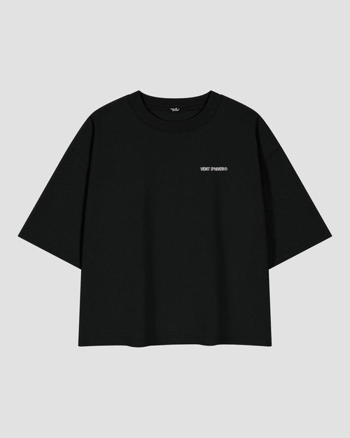 Black oversized heavyweight cotton T-shirt featuring a small white VENT D'HIVER® logo on the front chest. The back showcases a vintage monochrome illustration of Ma Barker holding a Thompson submachine gun, with large distressed "MA BARKER" typography and the phrase "FIERCEST WOMAN FROM OLD CHICAGO TOWN" beneath.