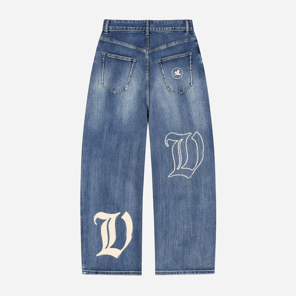 Blue jeans with white letter 'V' design on a light gray background