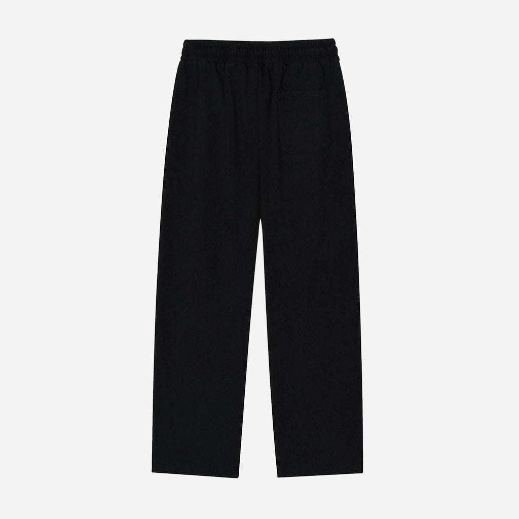 Black pants by VENT D'HIVER on a light gray background