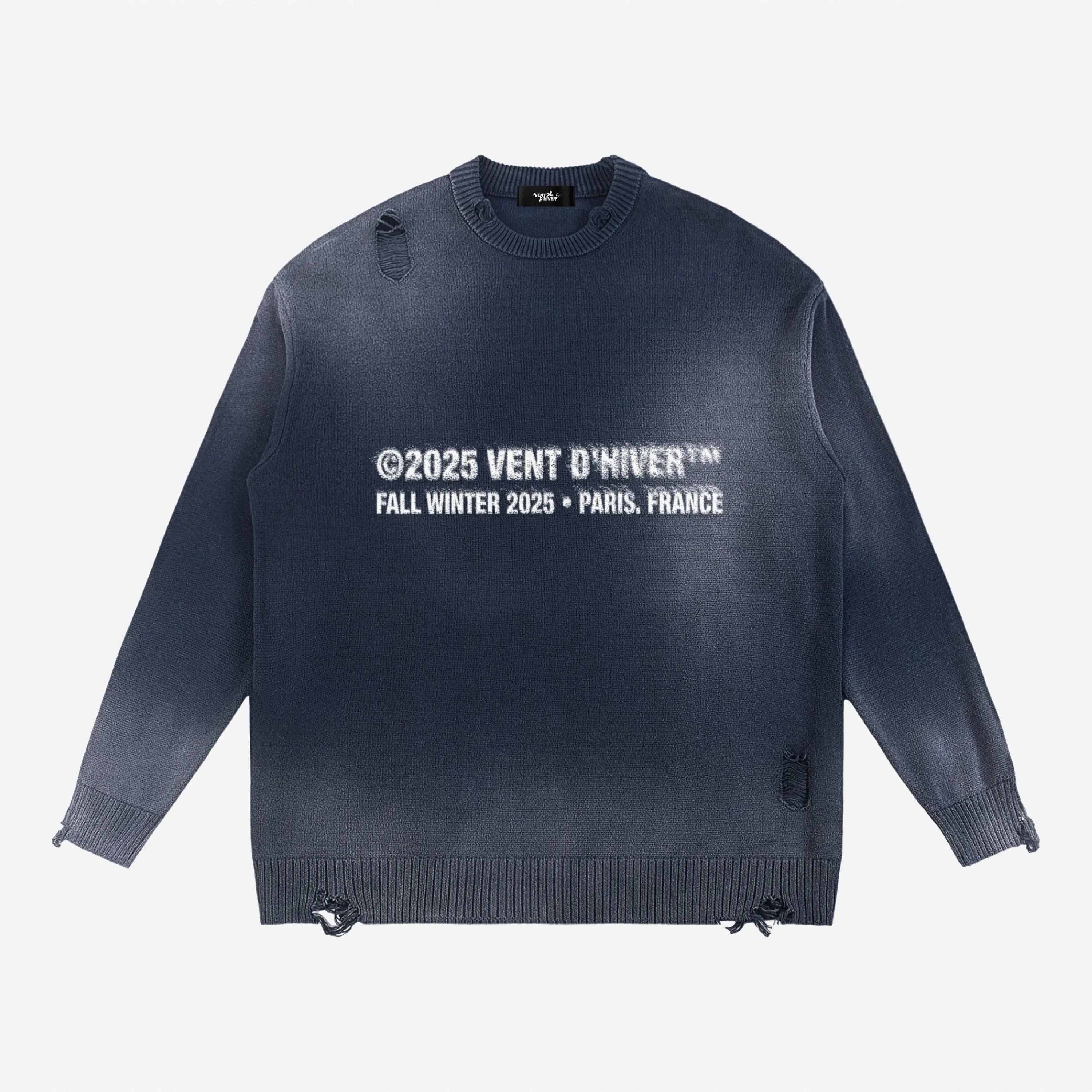 Navy sweater by VENT D'HIVER with white text on a light gray background
