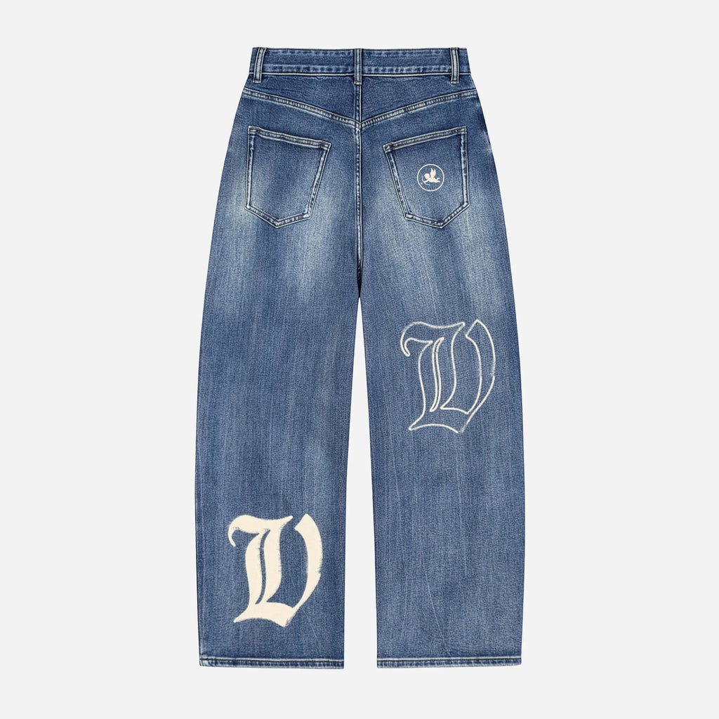 Blue jeans / denim by VENT D'HIVER with white letter 'V' design on a light gray background