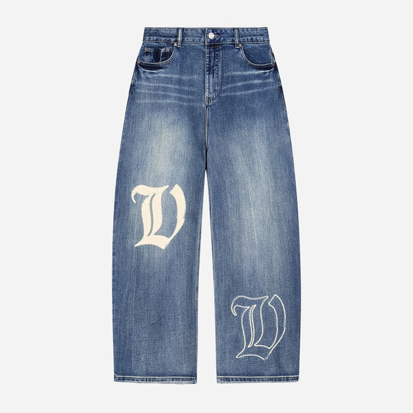 Blue jeans / denim by VENT D'HIVER with white letter 'V' design on a light gray background.